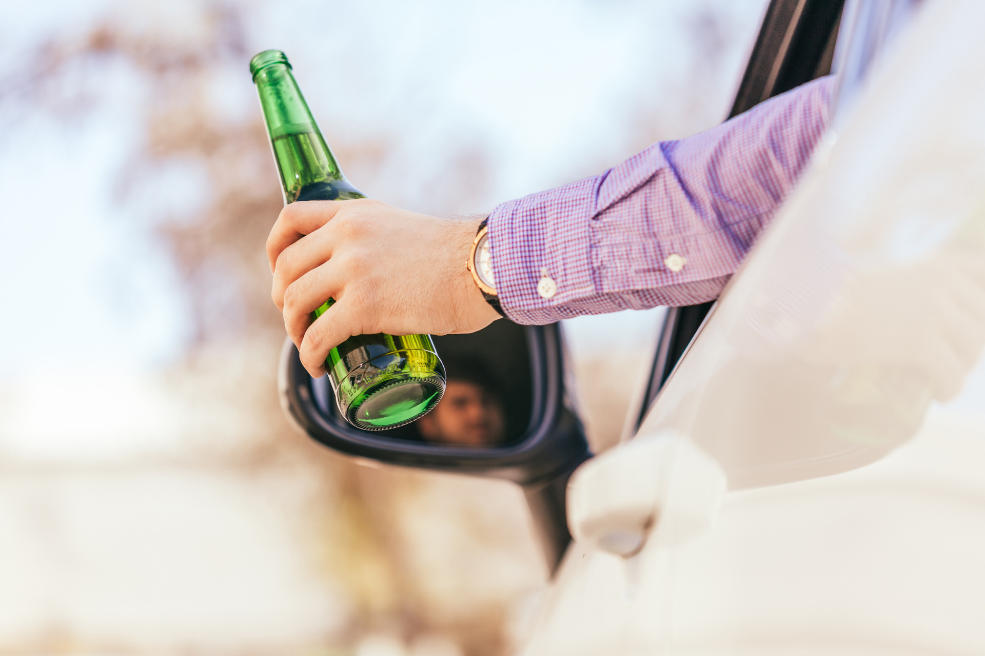 man drinking alcohol while driving