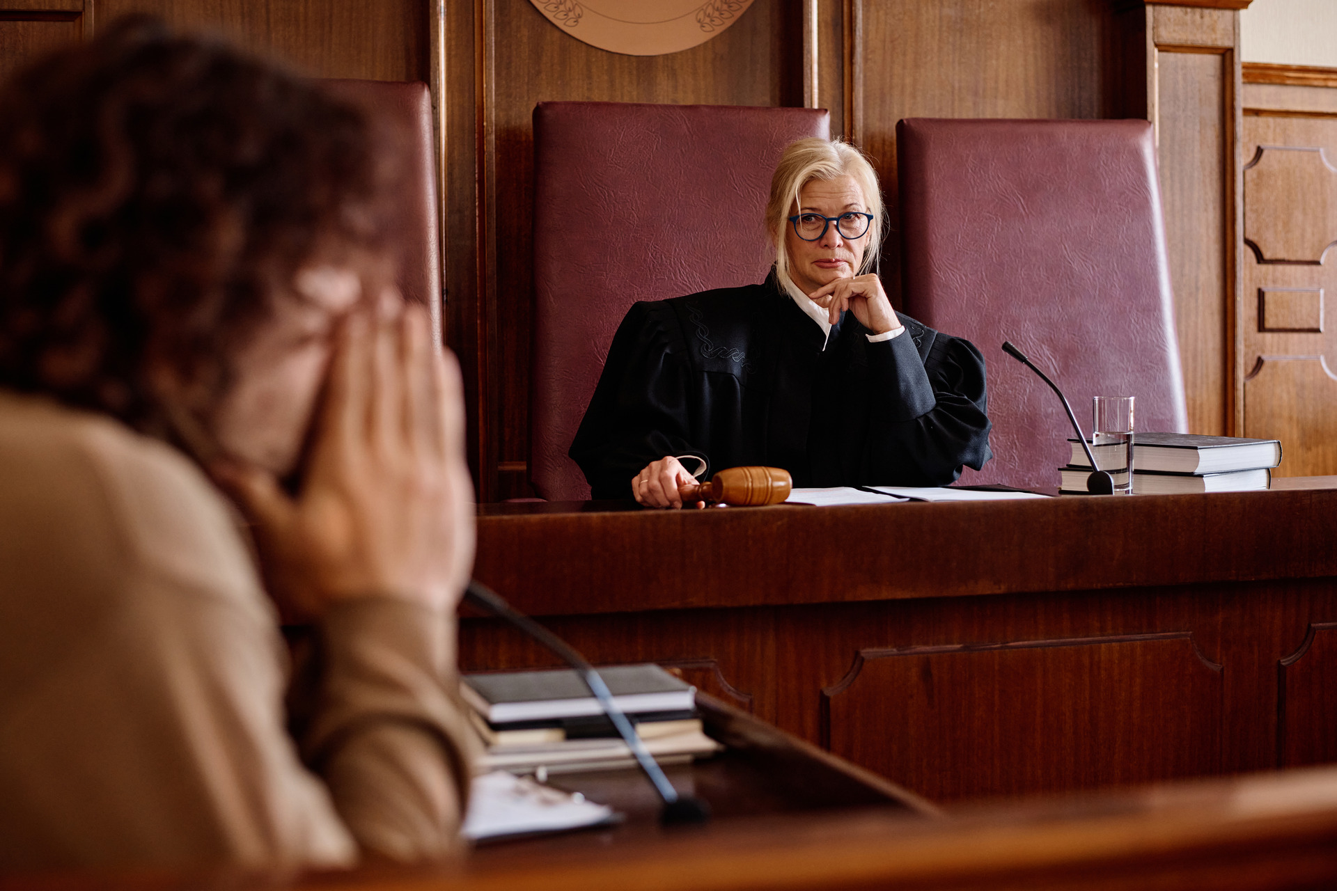 serious female judge looks at woman in a court