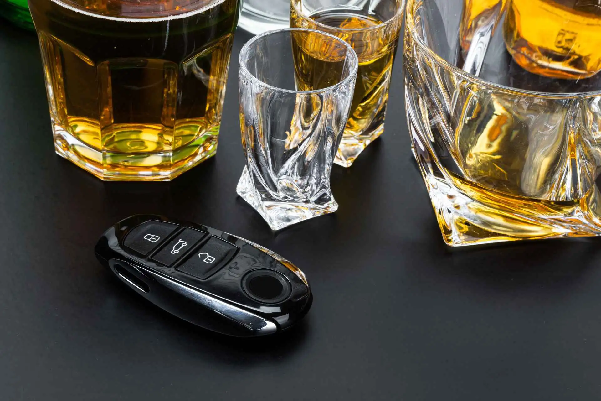 car key on the bar with spilled alcohol