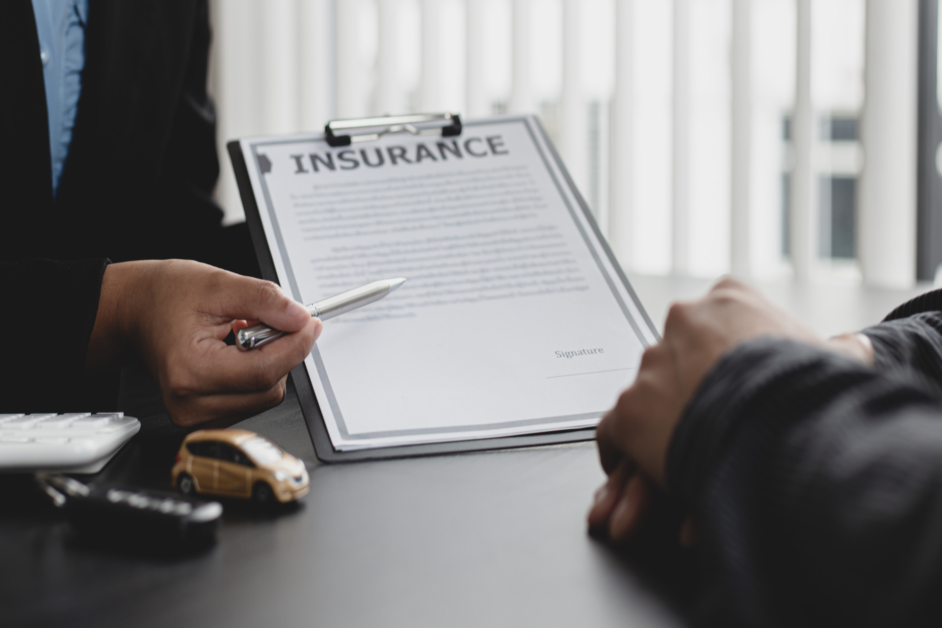 man representing document of car insurance coverage