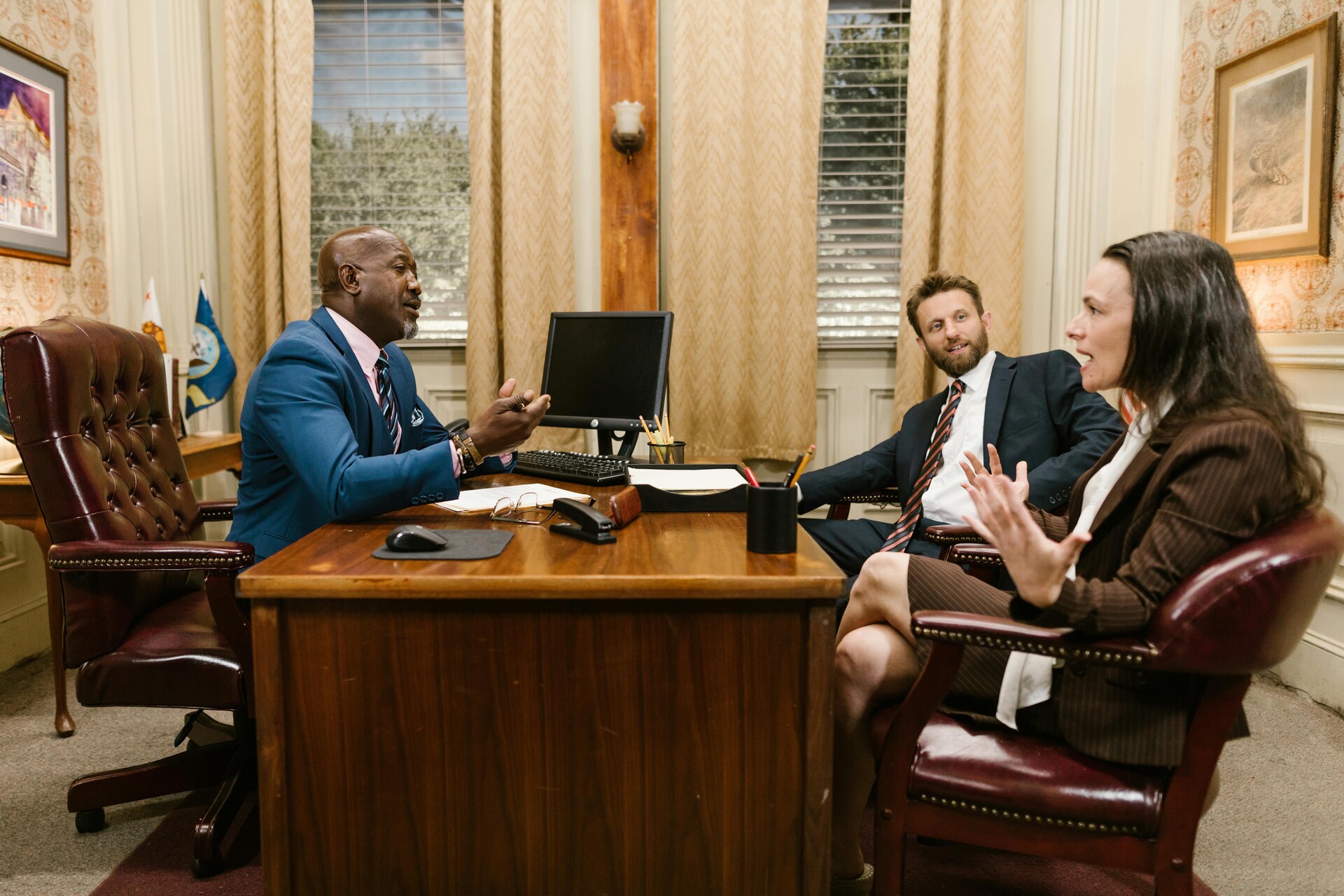 Lawyers and clients talking during a legal consultation in an office