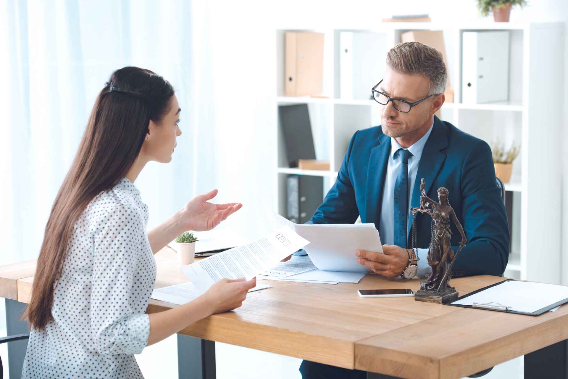 Client meeting with lawyer at desk