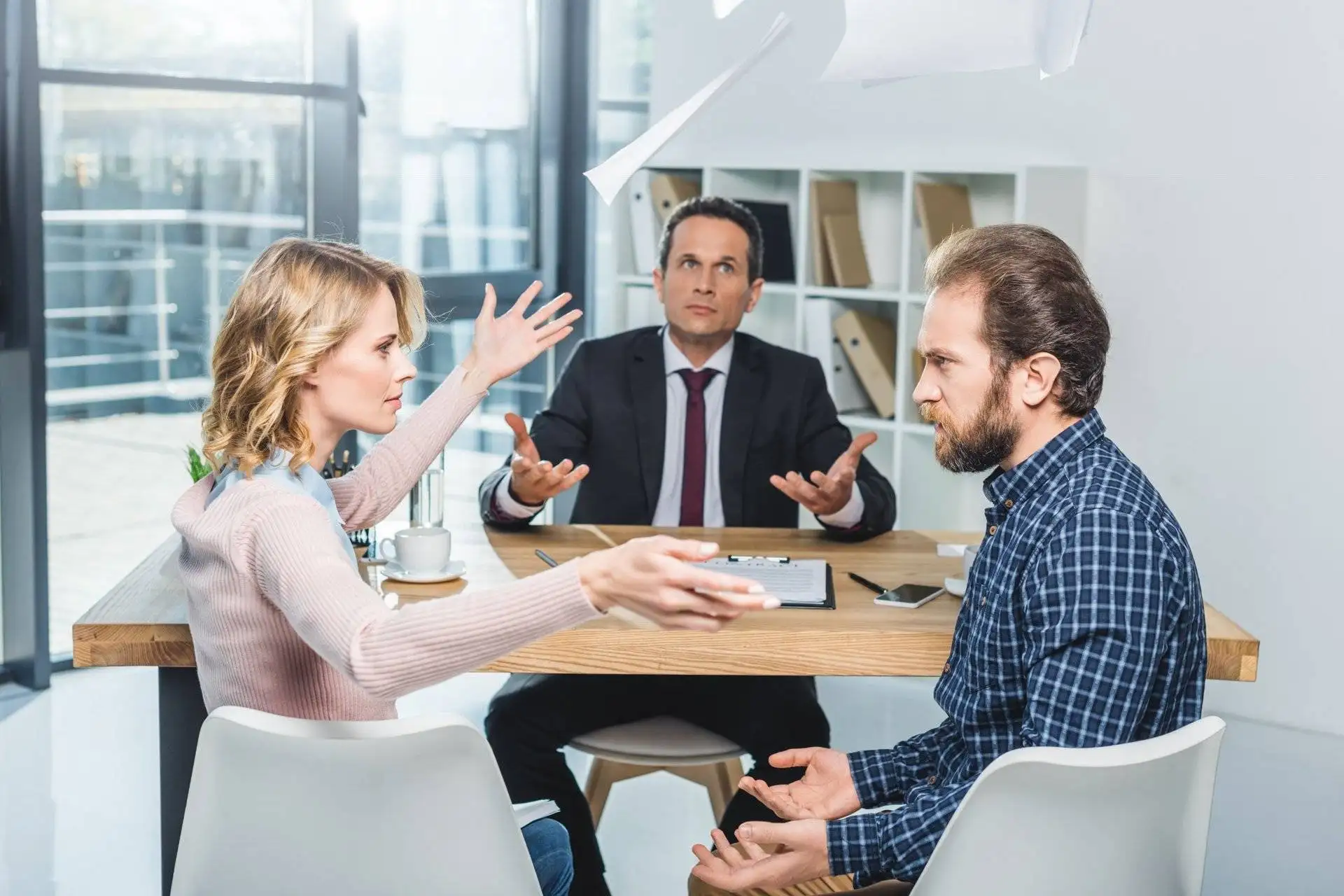 Couple arguing during tense meeting with mediator