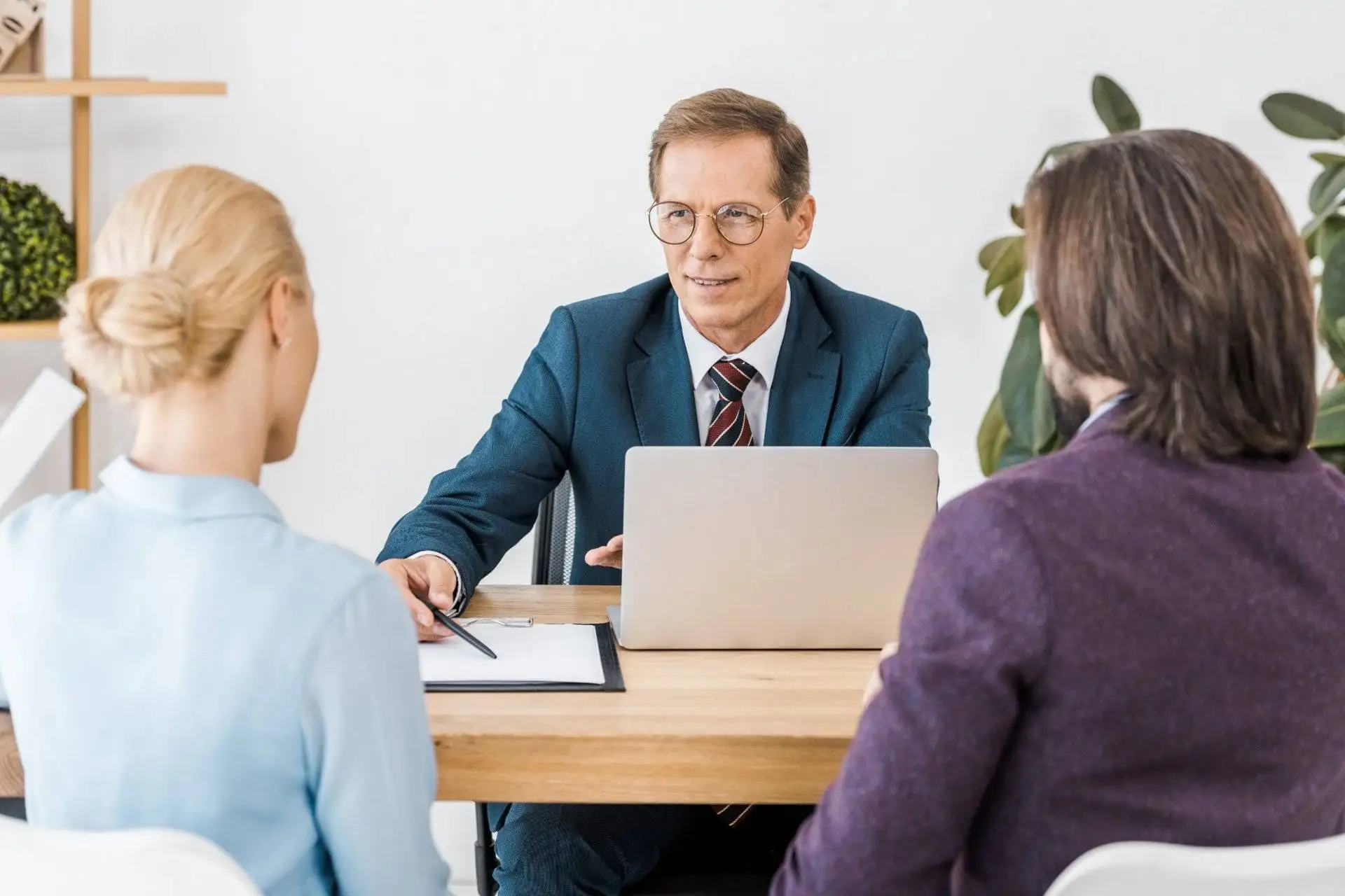 Lawyer consulting with a young couple at a desk