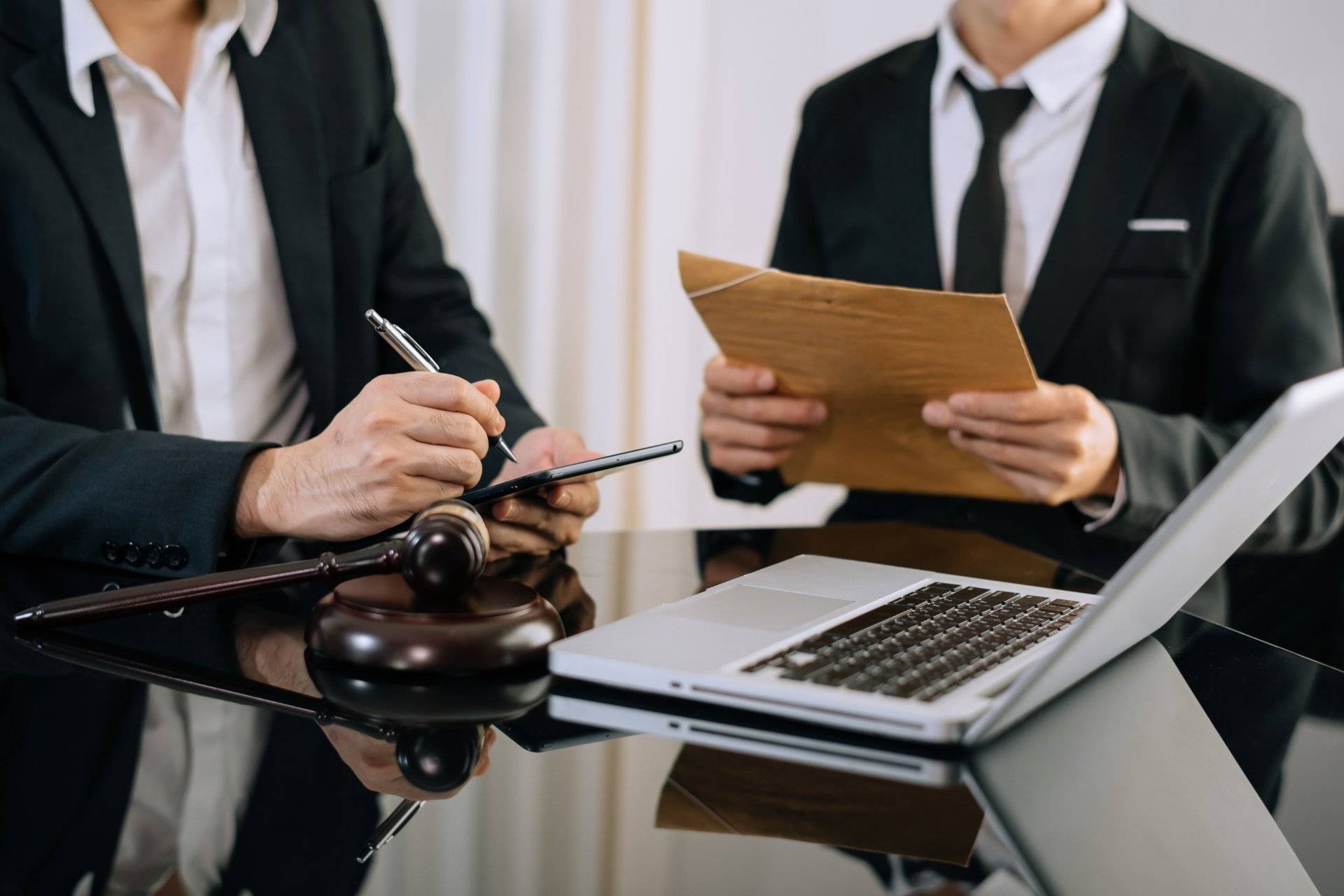 Lawyers reviewing contract details at office desk