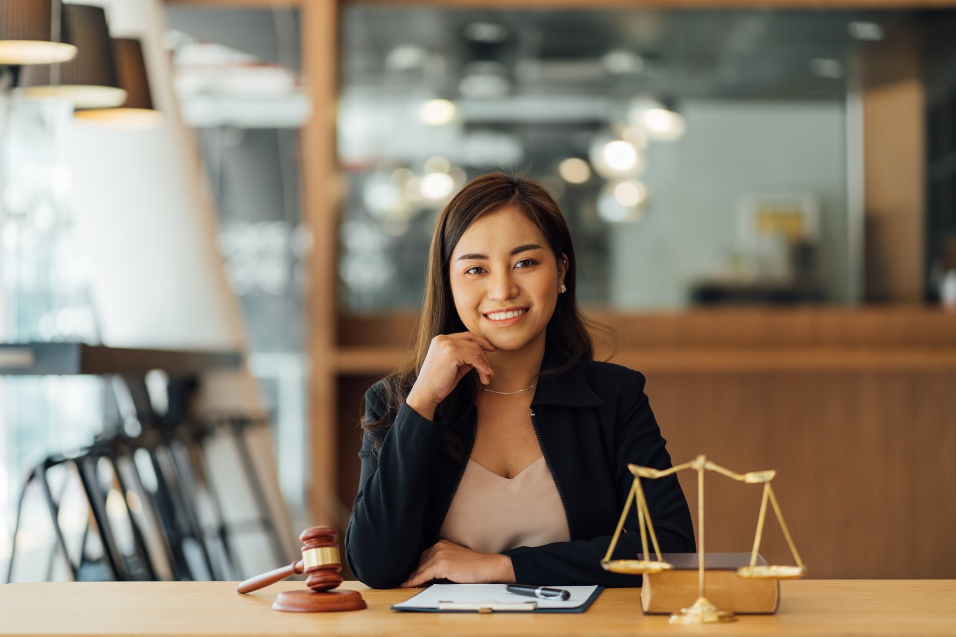 Confident female lawyer working at her desk with legal books
