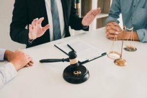 Lawyer calming down couple during a tense divorce discussion