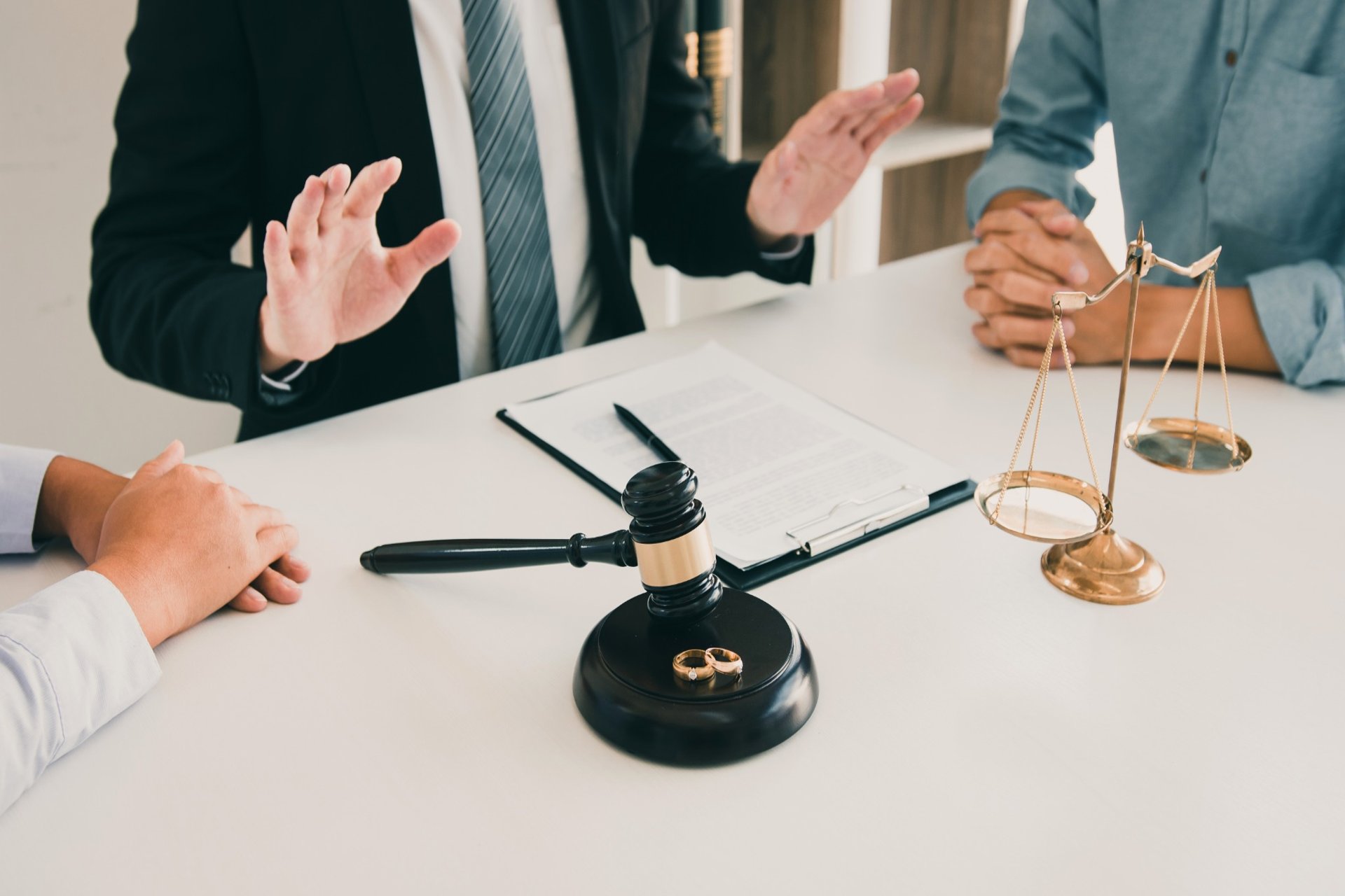 Lawyer calming down couple during a tense divorce discussion