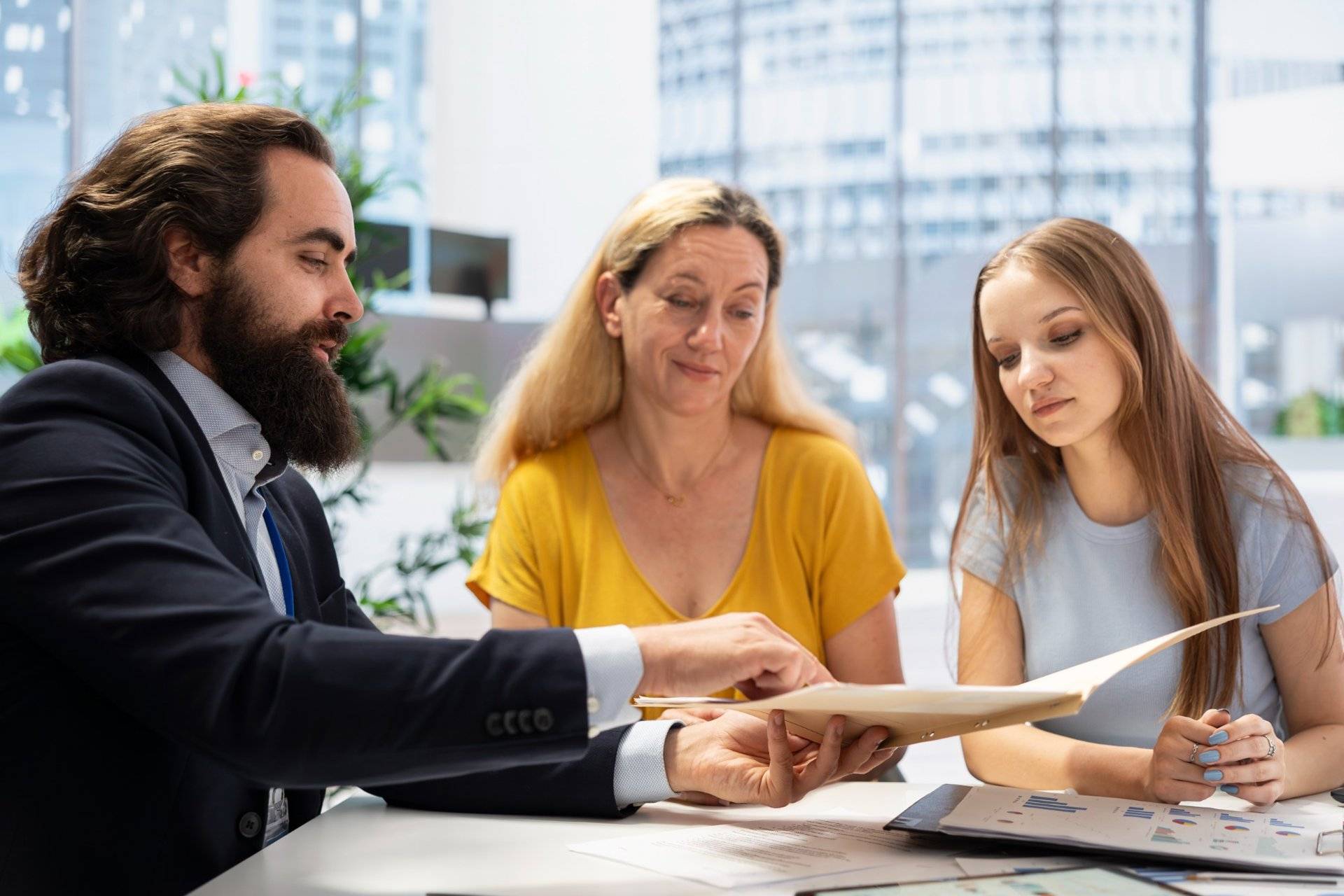 Lawyer discussing documents with a family in a modern office