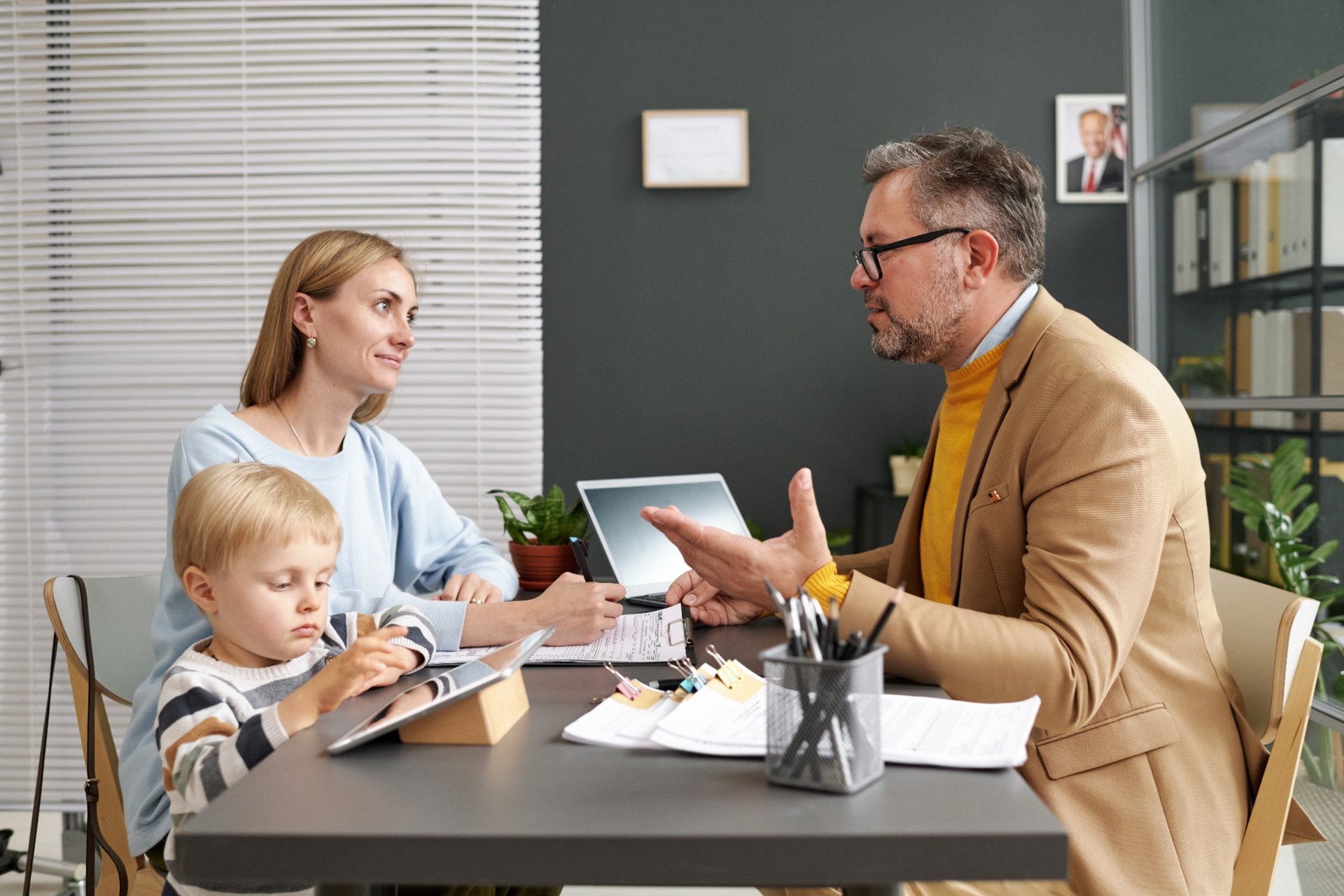 Lawyer talking with a mother and child about adoption paperwork
