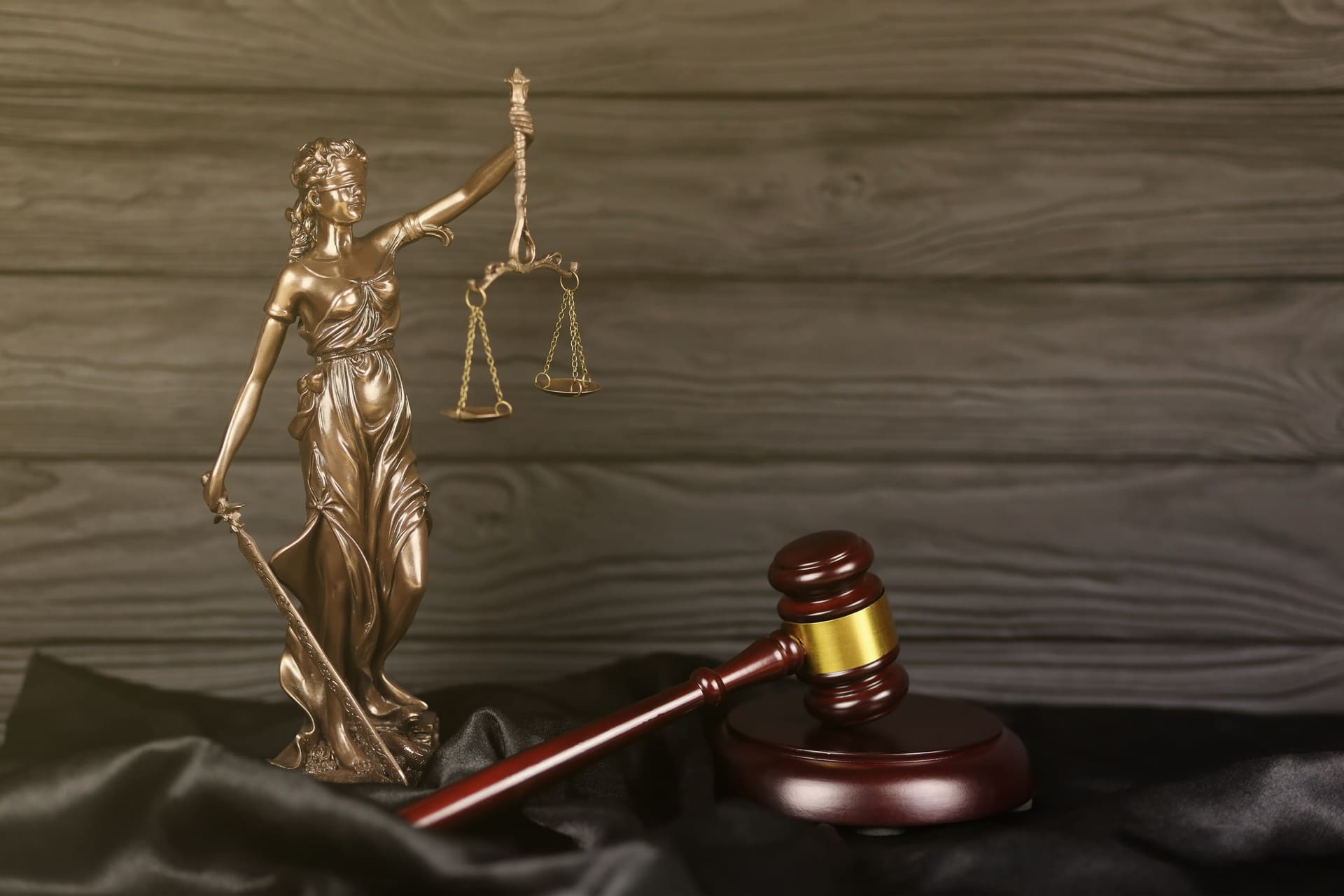 Lady Justice statue with a judge's gavel on a table