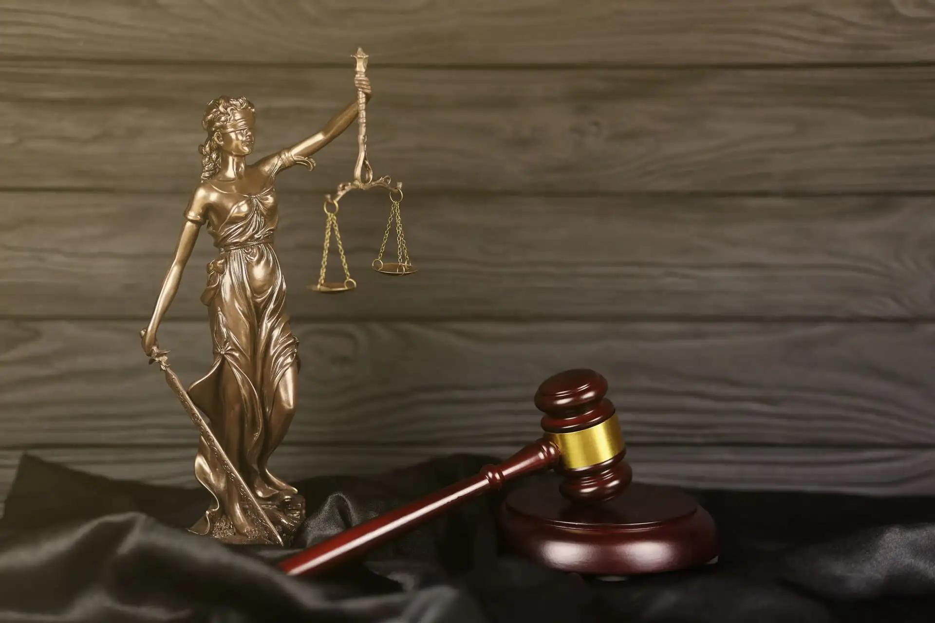 Lady Justice statue with a judge's gavel on a table