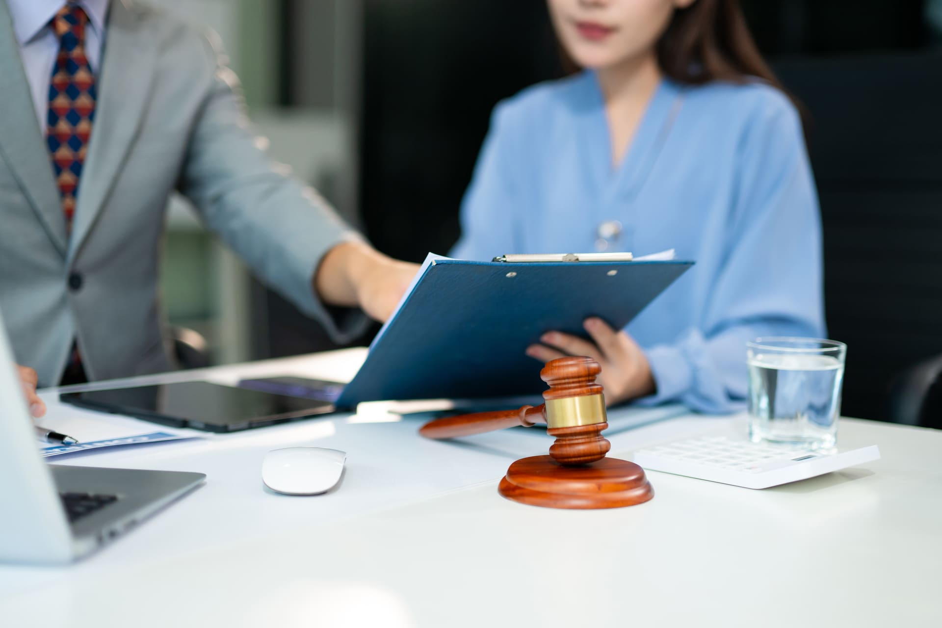 Lawyers reviewing legal documents at a desk with a gavel