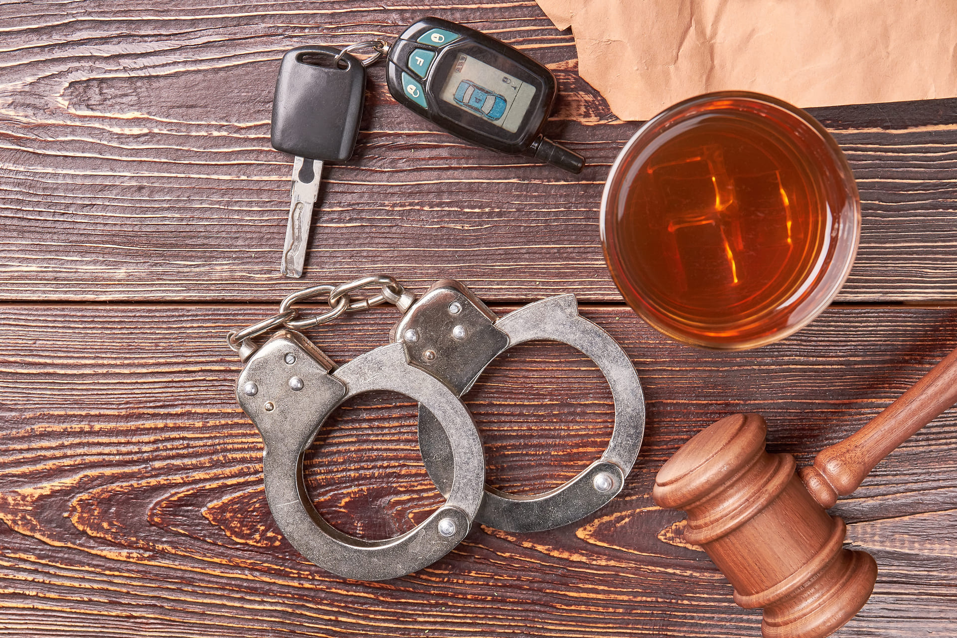 gavel key handcuffs and whiskey top view