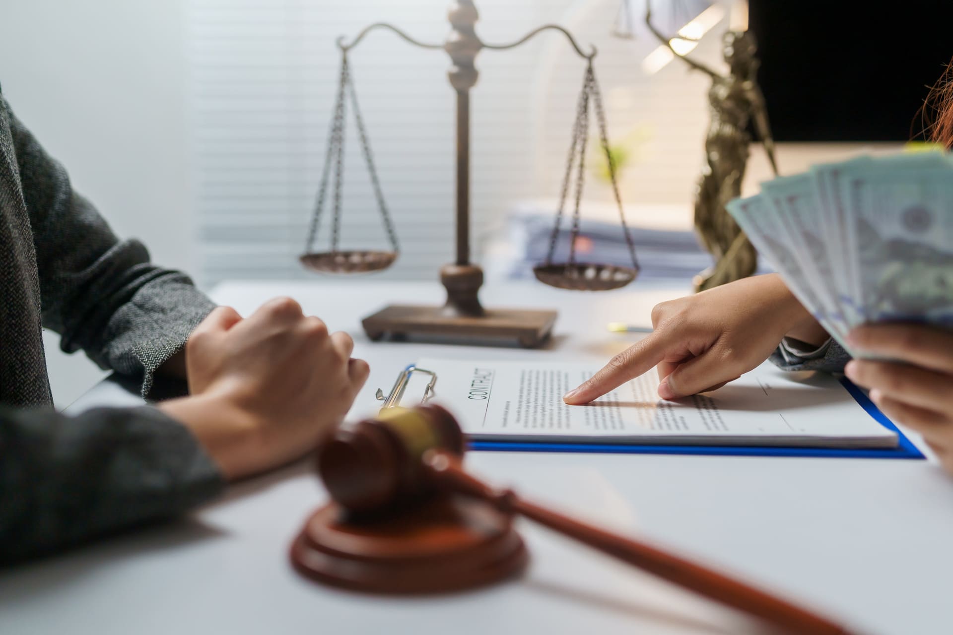 Lawyer discussing case with client pointing at document