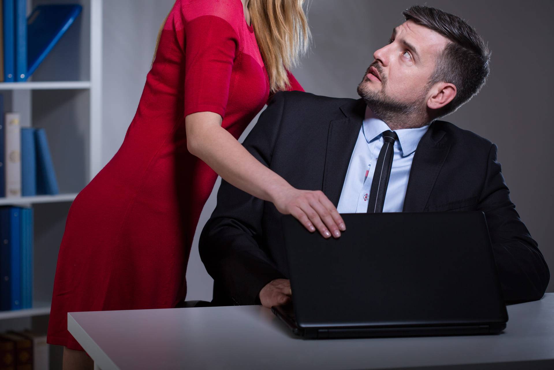 woman sexually harassing man at the workplace