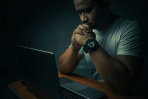 Man looking at computer - digital crime evidence.