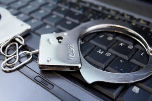 Stylized image of handcuffs on a laptop keyboard